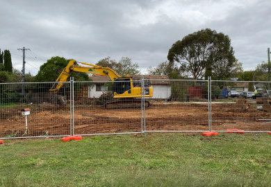 Fenced block with excavator