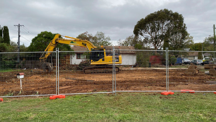 Fenced block with excavator